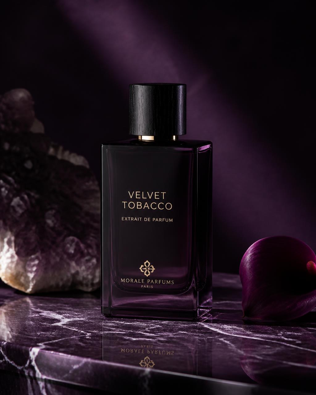 Minimalist bottle of Velvet Tobacco perfume on a dark purple marble surface